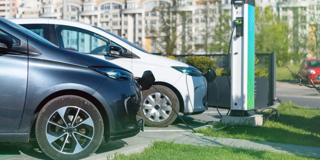 Two charging electric cars at charge station in the city